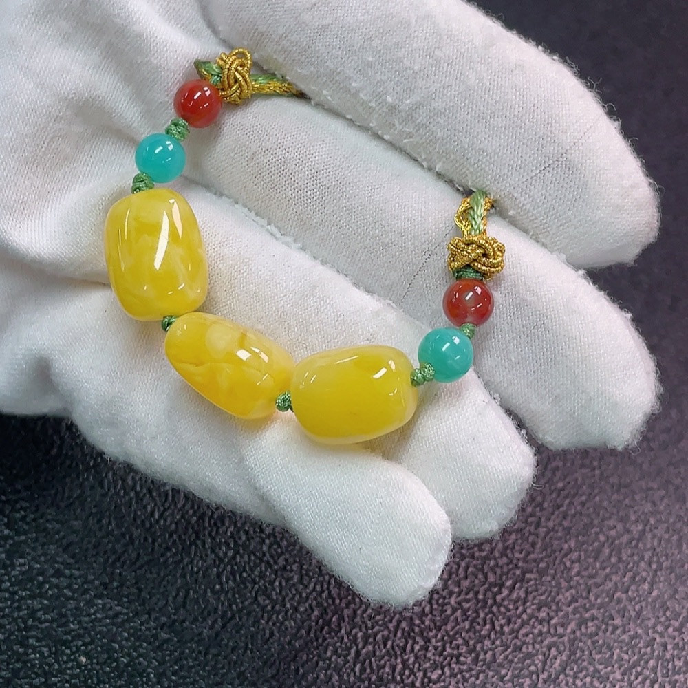 C34990683 Amber beeswax pendant with non-natural decorative stones, total weight approx. 7.47g (including cord), size approx. 11.4mm