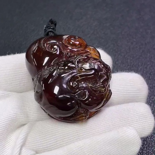C30473941 Amber honey wax pendant, total weight about 23.66g including rope