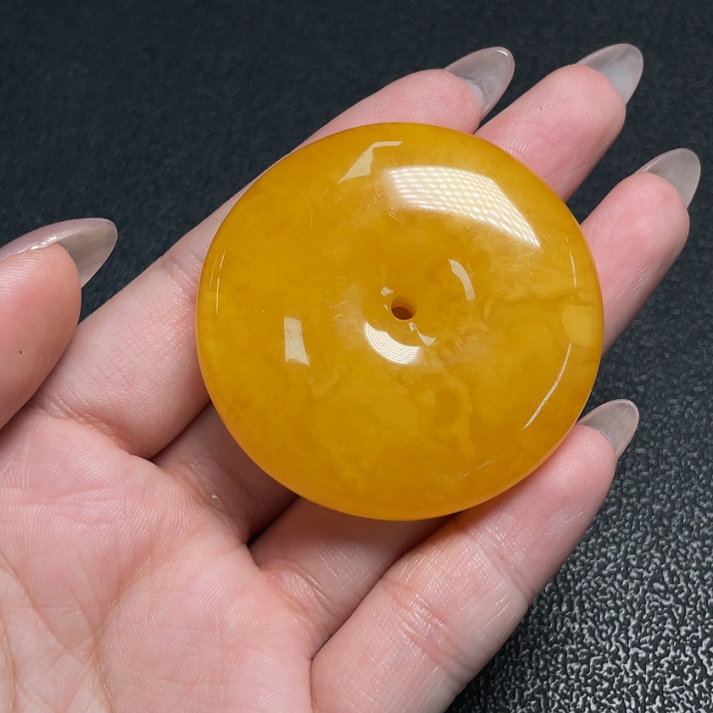 C34009607 Amber Beeswax Pendant with a total weight of approximately 17.71 grams