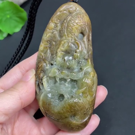 H22439310 Hetian Jade Pendant  Dragon  Total Weight (including rope) 139.7g  Undetermined skin color origin  Contains other natural mineral components