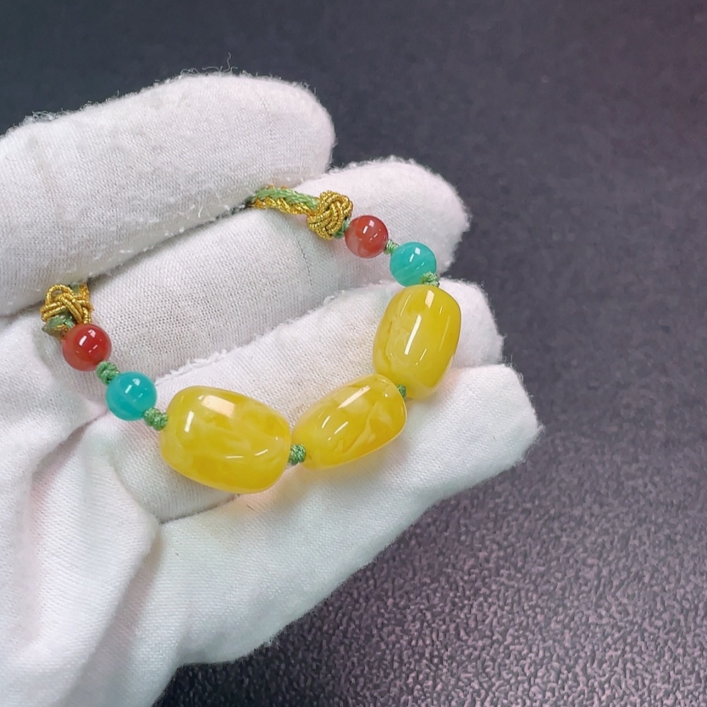 C34990683 Amber beeswax pendant with non-natural decorative stones, total weight approx. 7.47g (including cord), size approx. 11.4mm