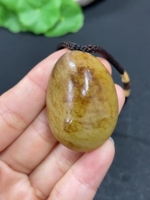 H46559688 和田玉挂件      货品总重约（含绳）32.3g    皮色成因未定   含其他矿物成份