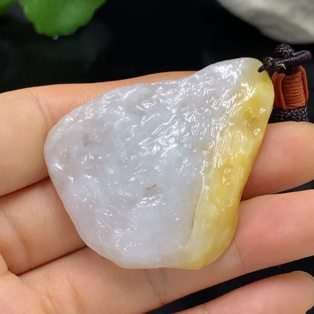 F28268126 Jadeite free-form pendant with a total weight of approximately 29.31g (including cord), color origin undetermined