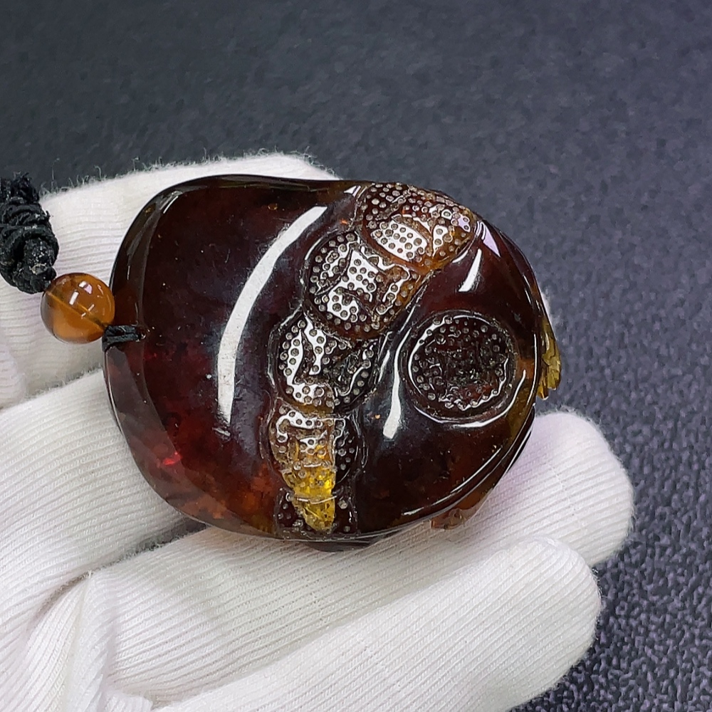 C30473941 Amber honey wax pendant, total weight about 23.66g including rope