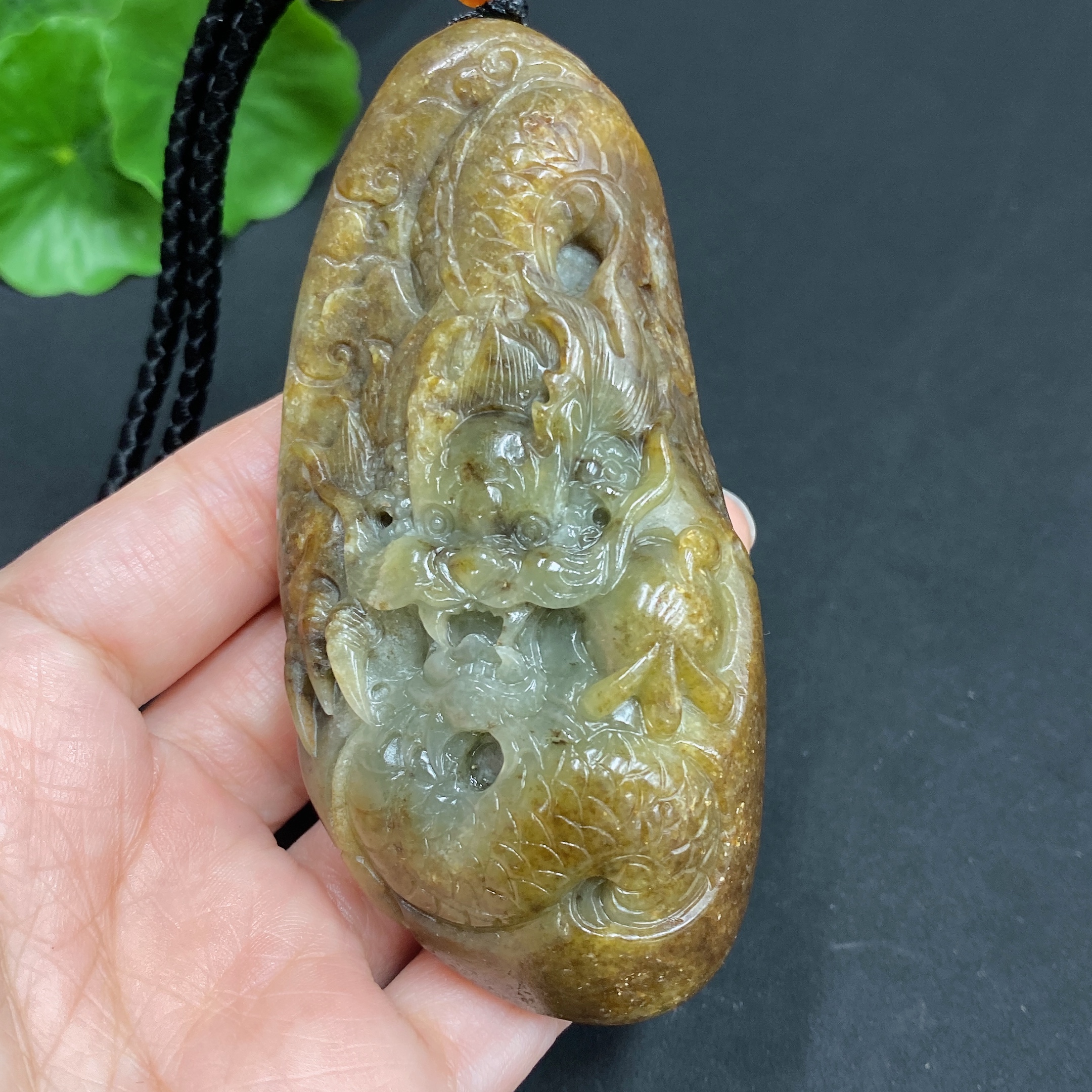 H22439310 Hetian Jade Pendant  Dragon  Total Weight (including rope) 139.7g  Undetermined skin color origin  Contains other natural mineral components