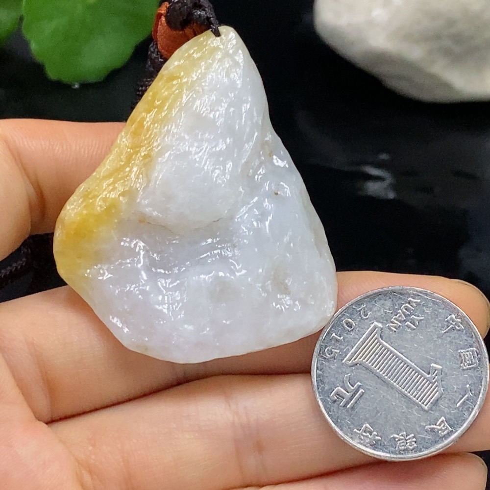 F28268126 Jadeite free-form pendant with a total weight of approximately 29.31g (including cord), color origin undetermined