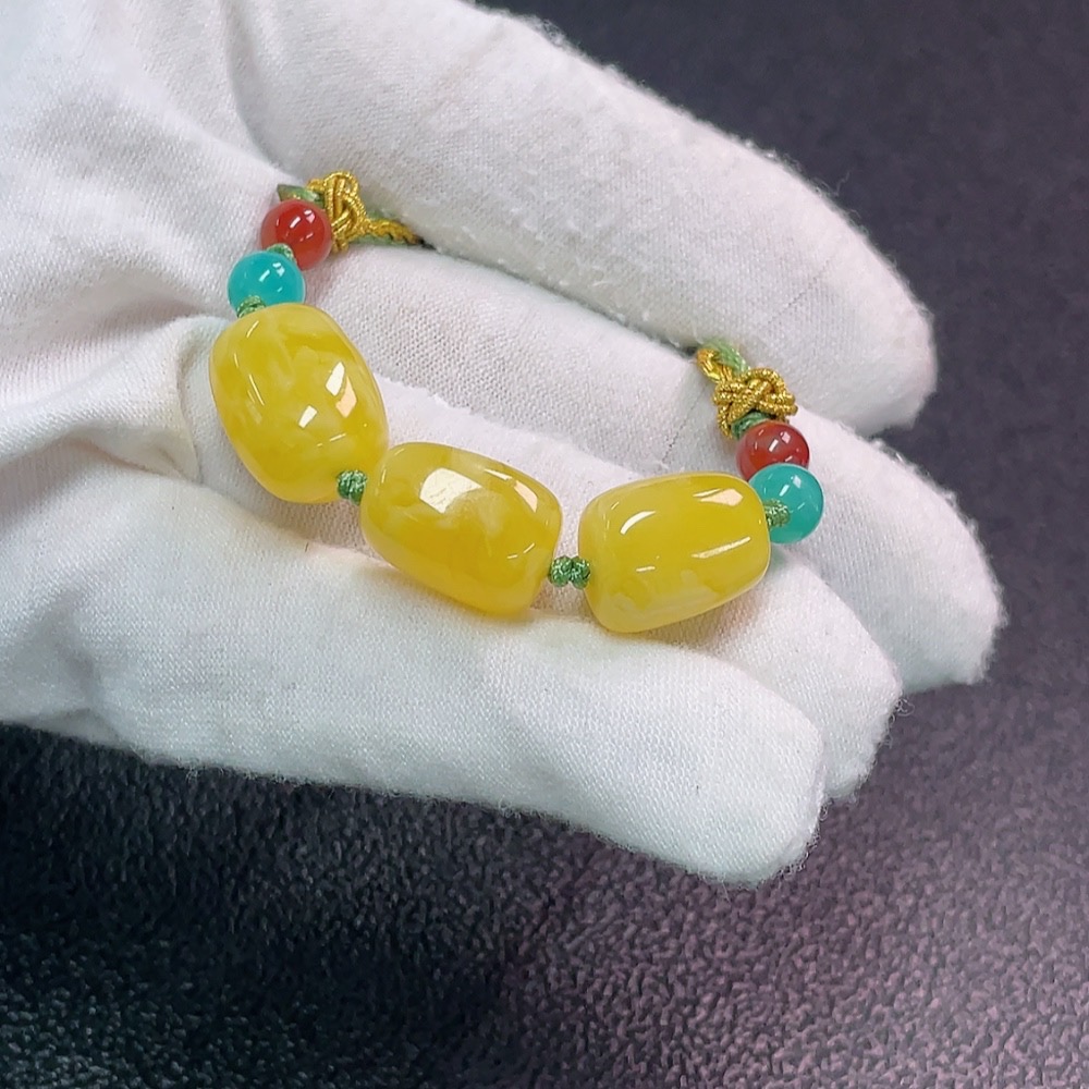 C34990683 Amber beeswax pendant with non-natural decorative stones, total weight approx. 7.47g (including cord), size approx. 11.4mm