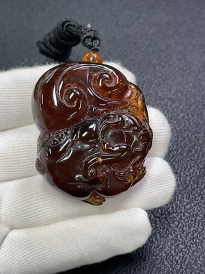 C30473941 Amber honey wax pendant, total weight about 23.66g including rope