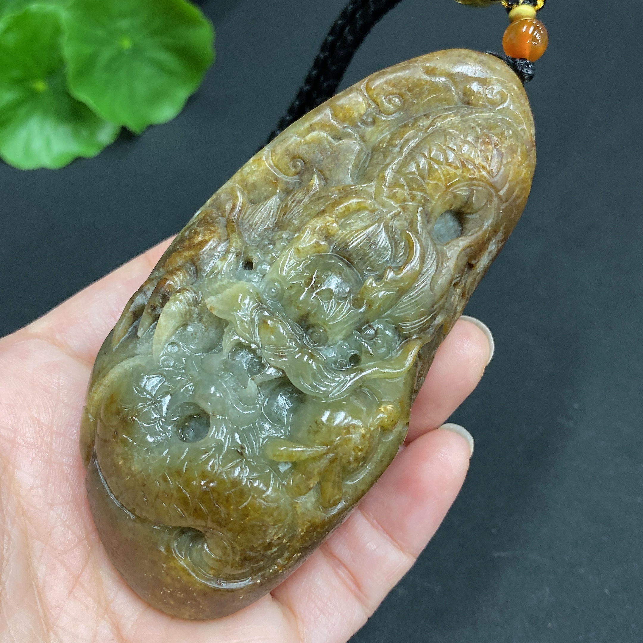 H22439310 Hetian Jade Pendant  Dragon  Total Weight (including rope) 139.7g  Undetermined skin color origin  Contains other natural mineral components